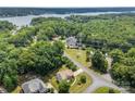 Aerial view of a home surrounded by lush greenery, near a lake, with neighborhood amenities nearby at 329 Squirrel Ln, Clover, SC 29710