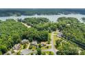Beautiful aerial view of homes and lakefront property surrounded by lush green trees and a tranquil lake at 329 Squirrel Ln, Clover, SC 29710