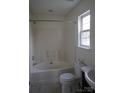 Clean bathroom featuring a tub and shower, a toilet, and a single sink vanity at 4718 Sahalee Ln, Charlotte, NC 28216