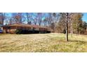 Sprawling brick home with large front yard and mature trees provides great curb appeal at 4937 Lebanon Dr # 1, Charlotte, NC 28273
