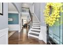 Elegant foyer with dark hardwood floors and a staircase with wrought iron spindles at 5019 Mill Creek Rd, Clover, SC 29710