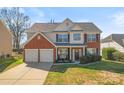 Charming two-story home featuring a brick and siding exterior, two-car garage, and well-manicured lawn at 5841 Lagrande Dr, Charlotte, NC 28269