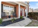 Inviting front porch with comfortable seating, a stylish front door, and manicured landscaping at 5841 Lagrande Dr, Charlotte, NC 28269