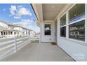 Open-air front porch featuring white railings and ample space, perfect for relaxing at 5950 Mantle Way, Kannapolis, NC 28081