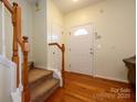 Inviting foyer with hardwood floors, staircase, and ample natural light at 8422 Chaceview Ct, Charlotte, NC 28269