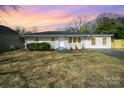 Lovely single-story home showcasing a beautiful sunset sky and appealing curb appeal at 8624 Sharonbrook Dr, Charlotte, NC 28210