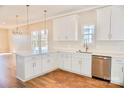 Well-equipped kitchen with stainless steel appliances, white cabinets and granite countertops at 926 Poplar St, Albemarle, NC 28001