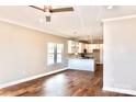Open-concept living space with hardwood floors, a ceiling fan and lots of natural light at 926 Poplar St, Albemarle, NC 28001