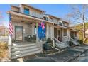 Townhome exterior showcasing a cozy front porch with outdoor seating at 100 Willow Run Dr, Gastonia, NC 28056