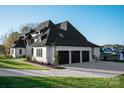 Attractive angle view showing the three car garage and white painted brick at 1004 Maxwell Ct # 1, Marvin, NC 28173