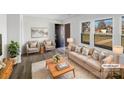 Staged living room showcasing neutral decor, lots of natural light, and modern flooring at 1188 Parkmont Ln, Rock Hill, SC 29730