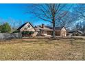 A lovely home exterior featuring a wooden fence and mature trees and shrubbery in the backyard for privacy and shade at 133 Persimmon Creek Rd # 81, Kings Mountain, NC 28086