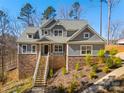 Charming home featuring stone accents, a welcoming front porch, and well-maintained landscaping at 13701 Petworth Ct, Charlotte, NC 28278