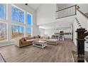 Spacious living room with soaring windows, and stairs leading to a second-floor landing at 13701 Petworth Ct, Charlotte, NC 28278