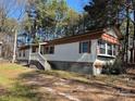 Exterior elevation of home with wood shutters and white trim, concrete perimeter foundation at 1406 Ratchford Dr, Dallas, NC 28034