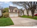 Charming two-story home featuring a two-car garage, red shutters, and a well-manicured lawn at 1452 Deer Forest Dr, Indian Land, SC 29707