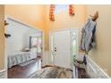 Bright foyer with hardwood floors, wainscoting, and a view into the adjacent bedroom with bay window at 1452 Deer Forest Dr, Indian Land, SC 29707