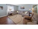 Inviting living room with hardwood floors, ample natural light, and a comfortable sectional sofa at 17118 Frog Pond Rd, Oakboro, NC 28129