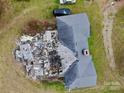 Aerial view of a house showing roof damage and debris in the back yard at 2126 W C St, Kannapolis, NC 28081