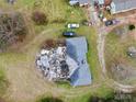 Aerial view of a home showing roof damage and debris in the back yard at 2126 W C St, Kannapolis, NC 28081