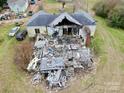 Aerial shot of a home showing fire damage and debris in the back yard at 2126 W C St, Kannapolis, NC 28081