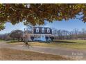 Expansive front yard with an inviting two-story home featuring dormer windows and mature trees at 2918 Medlin Rd, Monroe, NC 28112