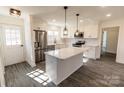Bright, renovated kitchen with white cabinets, stainless steel appliances, and a center island at 2918 Medlin Rd, Monroe, NC 28112