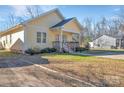 Inviting yellow home with a covered porch and tidy landscaping enhances its curb appeal at 293 Blanche Cir, Rock Hill, SC 29730