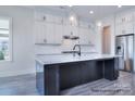 Modern kitchen features stainless steel appliances, a large island, and elegant pendant lighting at 338 Shinnville Rd, Mooresville, NC 28115