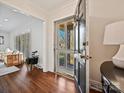 Bright entryway featuring hardwood floors, a black door, and a view into the elegant living room at 410 Moncure Dr, Charlotte, NC 28209