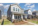 Attractive home featuring a charming front porch and well-maintained landscaping at 500 Cranford Dr # 73, Pineville, NC 28134