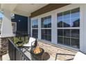 Inviting front porch featuring stylish seating and a cozy fire pit at 500 Cranford Dr # 73, Pineville, NC 28134