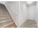 Bright entryway featuring neutral walls, luxury vinyl plank floors, and a staircase to the upper level at 5010 Arbordale Way # 5, Mount Holly, NC 28120