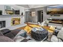 Comfortable living room featuring hardwood floors, a fireplace, and a tufted ottoman at 506 Coolidge Ct, Statesville, NC 28677