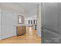 Warm entryway with hardwood floors, complemented by neutral walls and a glimpse into the living area at 721 Governor Morrison St # 408, Charlotte, NC 28211