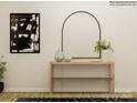 An entryway table decoratively staged with modern artwork and elegant decorative vases at 8418 Norman Forest Rd, Lancaster, SC 29720