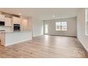 Open-concept living space featuring hardwood floors and backyard access at 8418 Norman Forest Rd, Lancaster, SC 29720