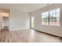 Bright living room features wood-look flooring and a glass door to the backyard at 8418 Norman Forest Rd, Lancaster, SC 29720