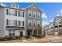 Beautiful townhouse showcasing neutral siding, elegant shutters, and a neatly landscaped lawn and welcoming front door at 1037 Naples Dr, Davidson, NC 28036