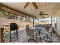 Spacious covered back deck featuring ceiling fans, grill, and outdoor dining furniture at 10722 Mountain Springs Dr, Charlotte, NC 28278