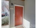 An eye-level view of the orange-colored front door with the address number at 1162 W 1St St, Charlotte, NC 28202