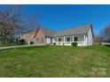 Beautiful one-story home with a large front yard and a classic white picket fence at 12012 Stainsby Ln, Charlotte, NC 28273
