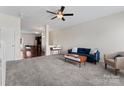 Spacious living room with plush carpet, ceiling fan, and ample natural light at 1205 Skywatch Ln, Monroe, NC 28112