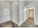 Hallway featuring a front door, neutral paint, and unique tile flooring at 125 Rocky Trail Ct, Fort Mill, SC 29715