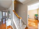 Welcoming entryway with hardwood floors, staircase, and decorative accents at 12642 Cardinal Woods Dr, Pineville, NC 28134