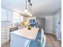Bright kitchen featuring stainless steel appliances, island seating, and modern fixtures at 12642 Cardinal Woods Dr, Pineville, NC 28134