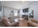 Cozy living room with modern flooring, plush sofa, mounted television, and natural light at 142 Westerwood Dr, Rock Hill, SC 29732