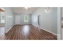 Open-concept living room featuring wood floors, light blue walls, and lots of natural light at 142 Westerwood Dr, Rock Hill, SC 29732