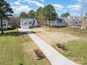 An elevated view of a beautiful house, surrounded by lush greenery and mature trees at 148 Painted Bunting Dr, Troutman, NC 28166