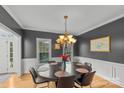 Sophisticated dining room featuring hardwood floors, wainscoting, and a modern chandelier above an oval dining table at 1919 46Th Avenue Ne Dr # 46, Hickory, NC 28601